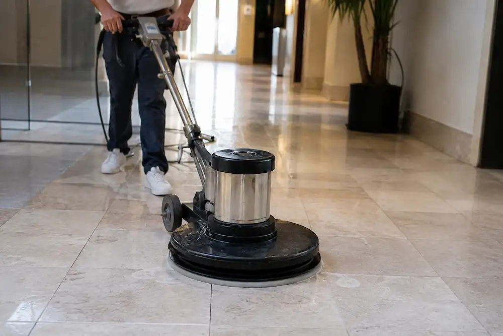 Commercial floor polishing machine cleaning natural stone tiles inside a modern building in Preston